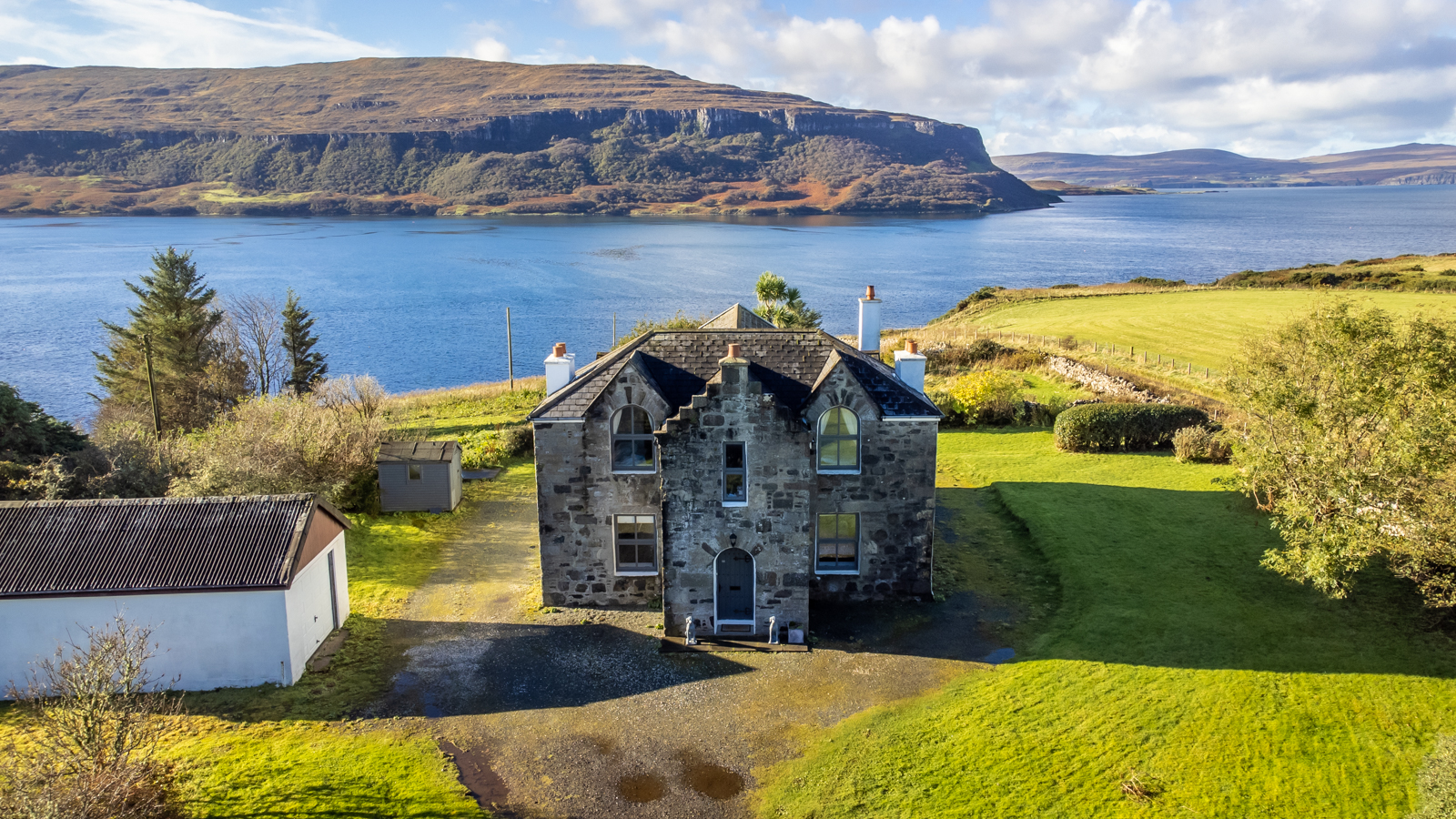 Lochbay House Sitting by a calm Loch