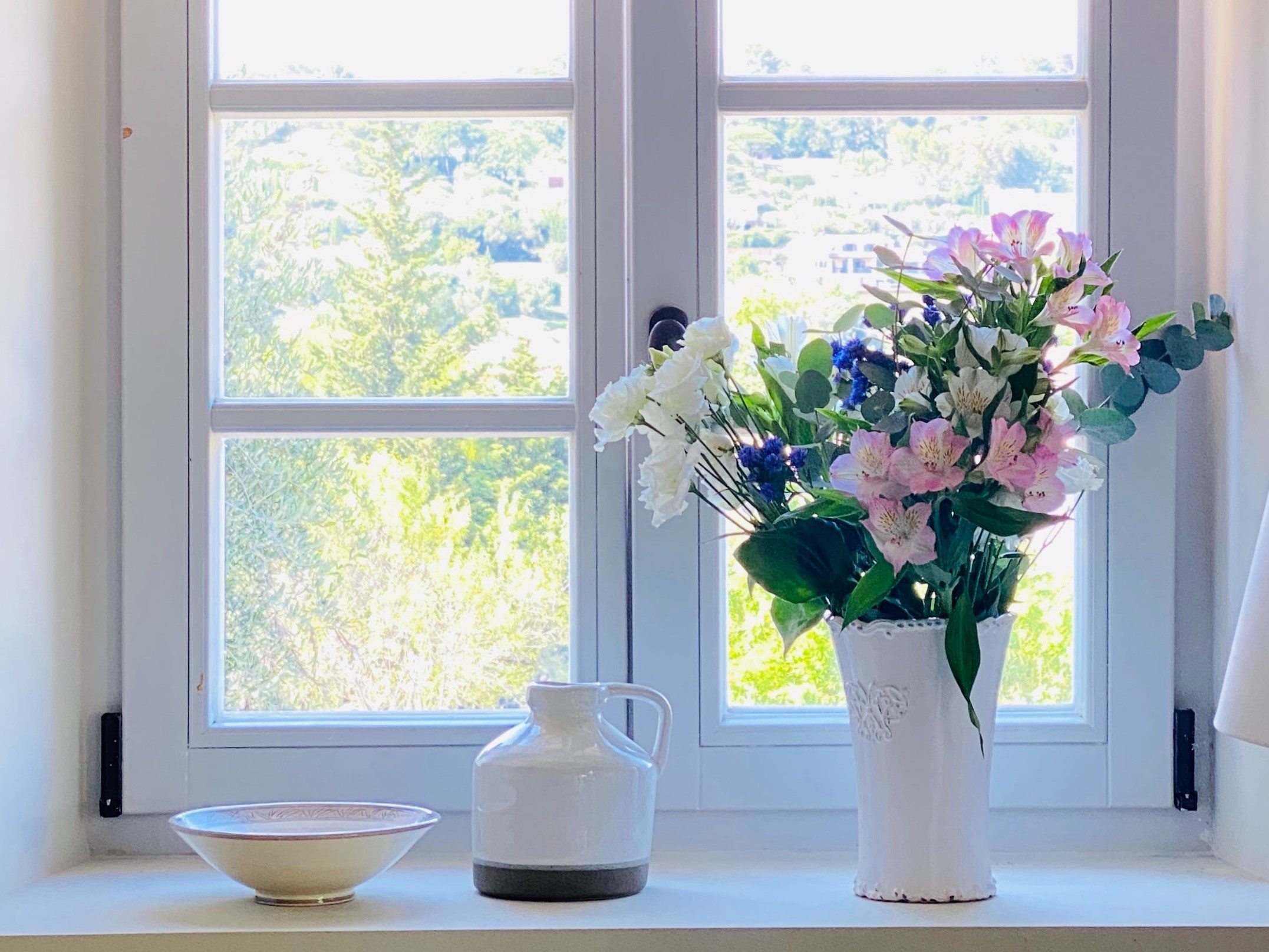 Flowers sitting by the window of a residential let